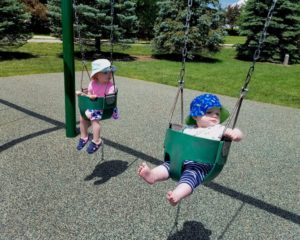 baby sibling swinging