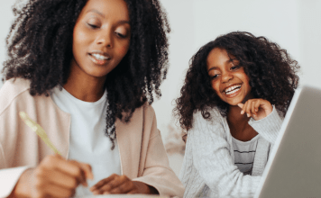 Mother writing notes with daughter
