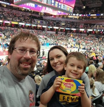 A man, women, and child inside Gainbridge Fieldhouse for Fever Game Day